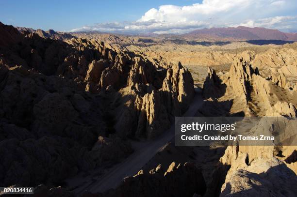 magical shapes of quebrada de las flechas - argentina dirt road panorama stock pictures, royalty-free photos & images