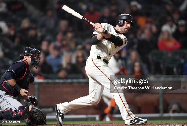 Conor Gillaspie of the San Francisco Giants hits a double against the Cleveland Indians in the bottom of the 10th inning at AT&T Park on July 18,...