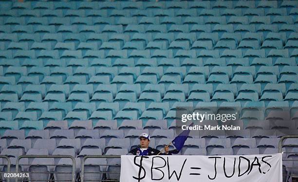 Bulldogs fan displays a sign in reference to Sonny Bill Williams in an empty section of the stadium during the round 20 NRL match between the St...