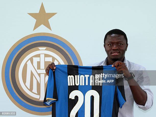 Football player Sulley Ali Muntari of Ghana shows his new Inter Milan jersey during his official presentation at the Inter Milan headquarter in Milan...