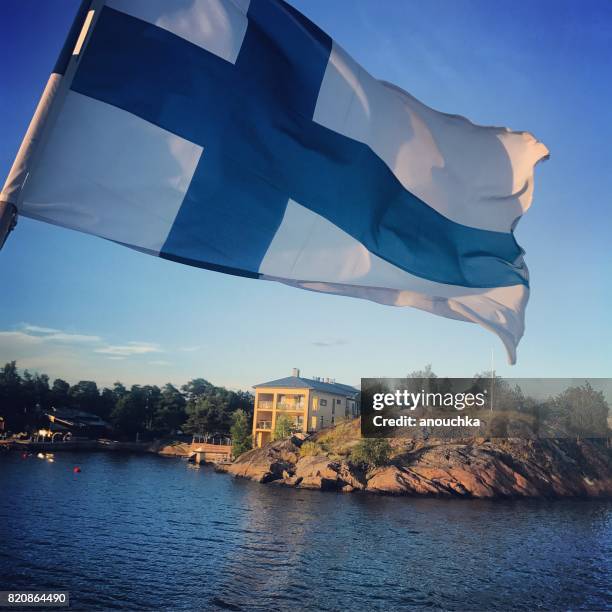 flag of finland on a ferry boat cruising around helsinki. - finish flag stock pictures, royalty-free photos & images