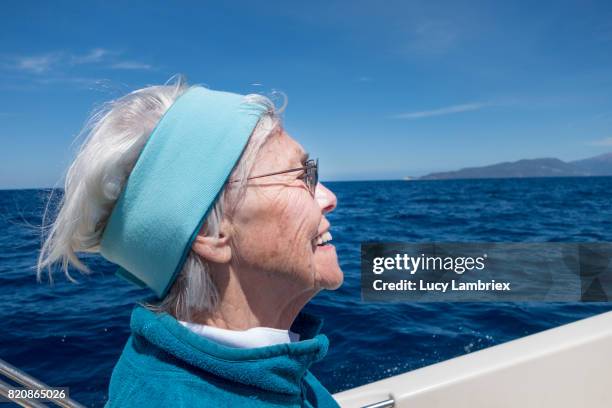 gritty women, senior woman boating - fiskardo stockfoto's en -beelden