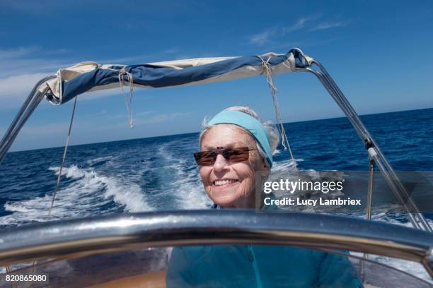 gritty women, senior woman boating - fiskardo stockfoto's en -beelden