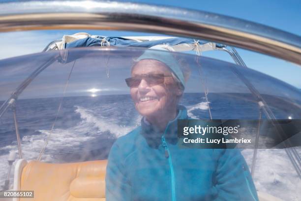 gritty women, senior woman boating - fiskardo stockfoto's en -beelden