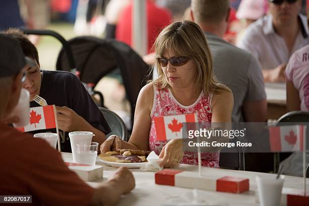 Woman settles down for a pancake breakfast as part of Canada Day festivities in this 2008 Penticton, British Columbia, Canada, summer photo. Canada...