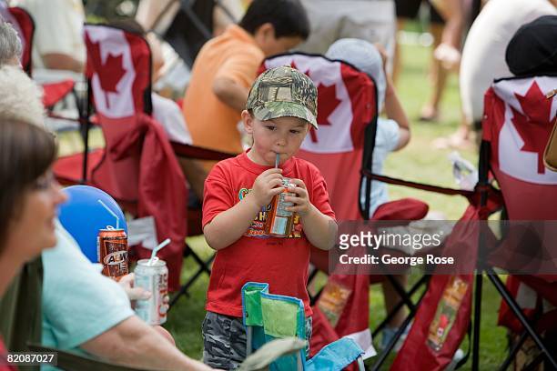Young boy sips soda from a can during Canada Day festivities in this 2008 Penticton, British Columbia, Canada, summer photo. Canada Day is the...