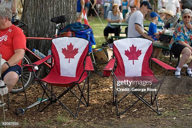 Two vacant Canadian maple leaf flag chairs are seen in this 2008 Penticton, British Columbia, Canada, Canada Day summer photo. Canada Day is the...