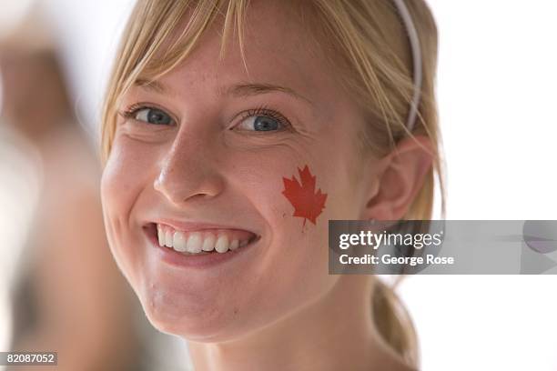 Young girl with a Canadian maple leaf flag sticker on her cheek waits for the Canada Day festivities to begin in this 2008 Penticton, British...