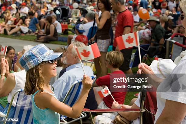 Young girl waves the Canadian maple leaf flag during Canada Day festivities in this 2008 Penticton, British Columbia, Canada, summer photo. Canada...