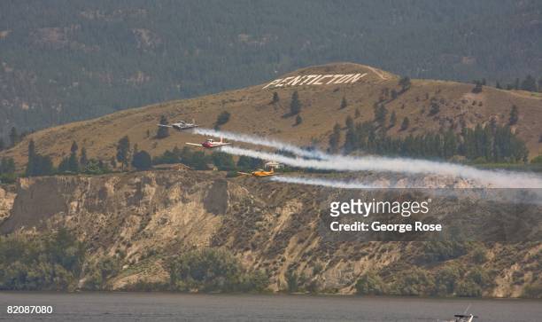 Aerial acrobatic planes fly overhead in formation during Canada Day festivities in this 2008 Penticton, British Columbia, Canada, summer photo....