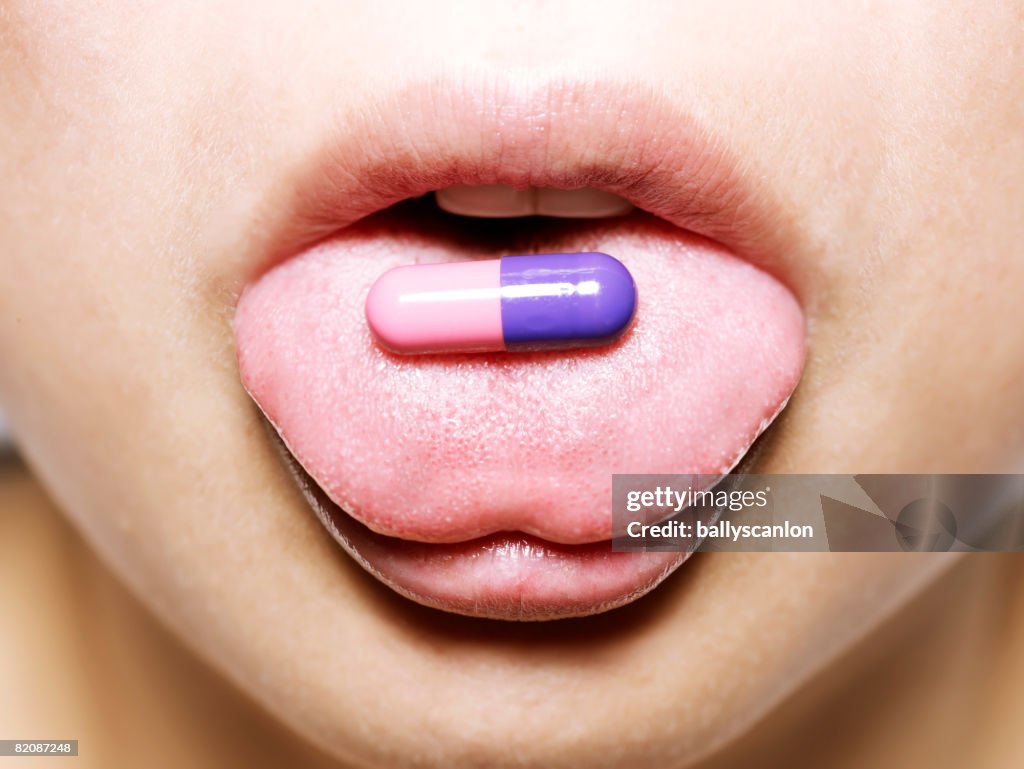 Young asian woman with medical pill
