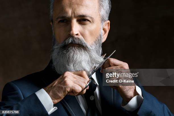 barber - beard trimming stock pictures, royalty-free photos & images
