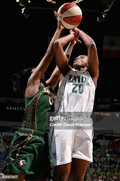 Charde Houston of the Minnesota Lynx goes up for a shot over Shrya Ely of the Seattle Storm during the WNBA game on July 22 , 2008 at Target Center...