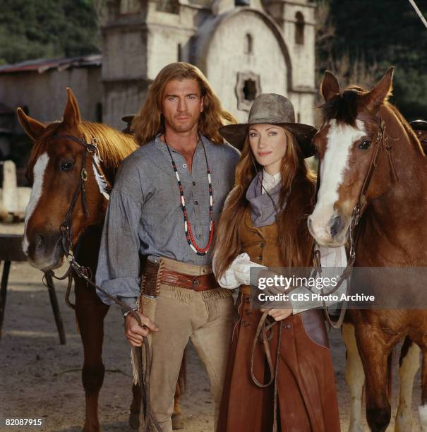 Promotional portrait of British actress Jane Seymour , as Dr. Michaela 'Mike' Quinn, and American actor Joe Lando, as Byron Sully, as they pose with...