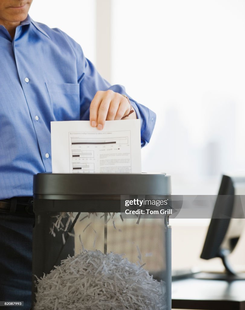 Shadding Paper Businessman Shredding Paper High-Res Stock Photo - Getty Images