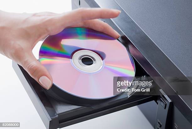 placing dvd into player - dvd stock pictures, royalty-free photos & images
