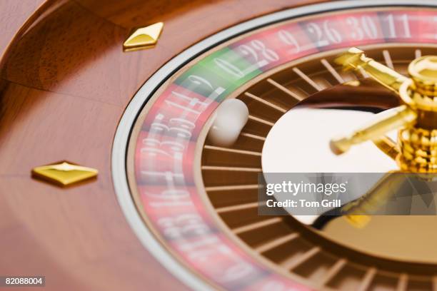 ball on a spinning roulette wheel - spinning wheel game stock pictures, royalty-free photos & images