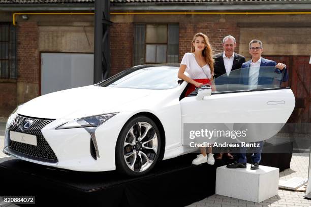 Sofia Tsakiridou, Frank Levy and Heiko Tvellmann pose in a Lexus at the 3D Fashion Presented By Lexus/Voxelworld show during Platform Fashion July...
