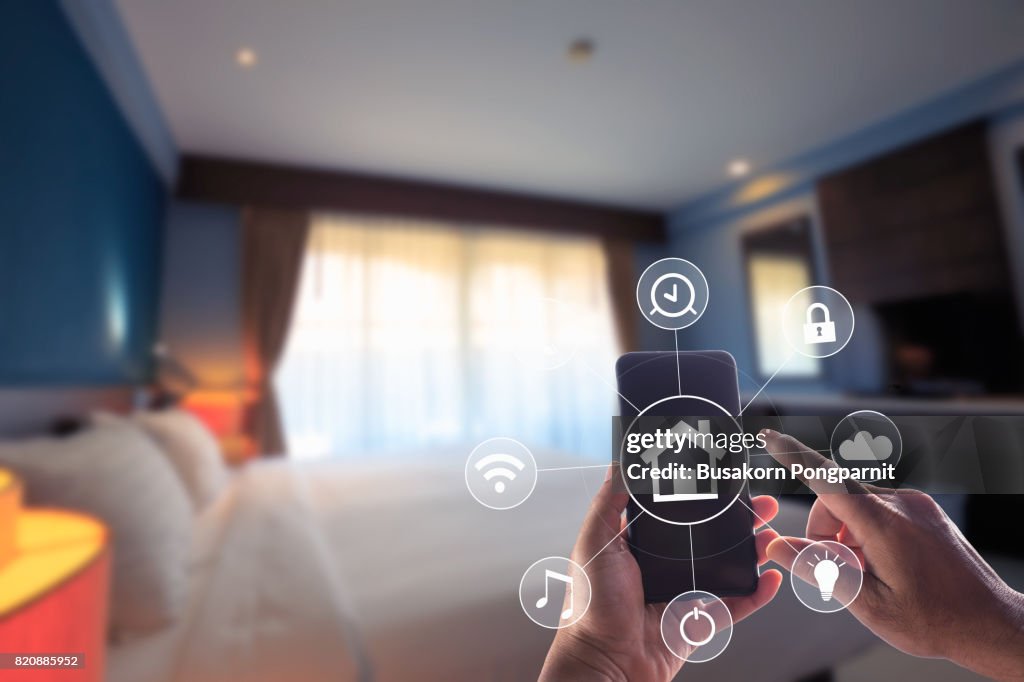 Smartphone remote home control system app. Bed Room interior in background.