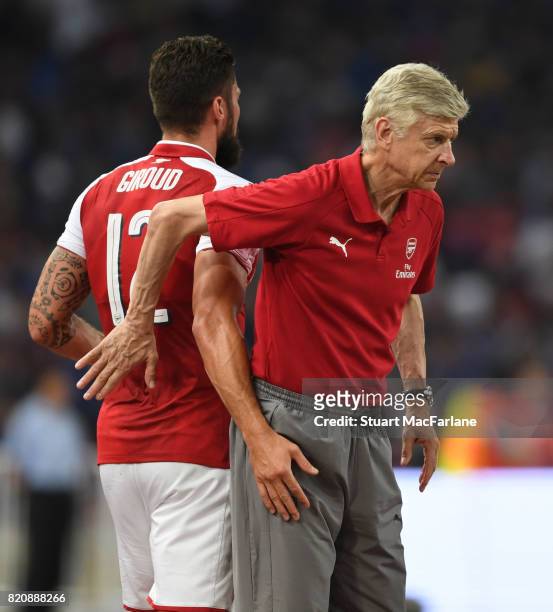 Arsenal manager Arsene Wenger with Olivier Giroud during the pre season friendly between Arsenal and Chelsea at the Birds Nest on July 22, 2017 in...
