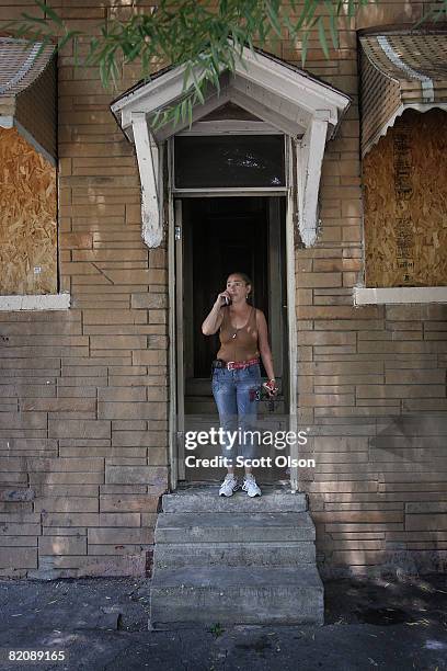 Luce Torrez stands on the front step of the home of her cousin, Maria Rolon, the day after a fire in the house killed one of Rolon's sons and...