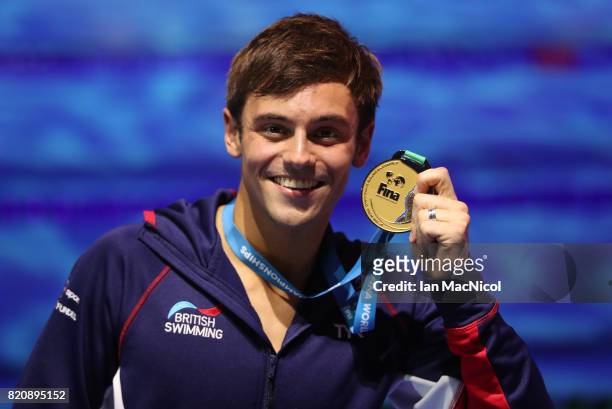 Tom Daley of Great Britain pose with his gold medal from the Men's 10m Platform during day nine of the FINA World Championships at the Duna Arena on...