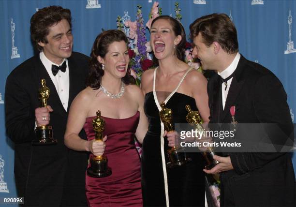 Best Supporting Actor Benicio Del Toro, left, Best Supporting Actress Marcia Gay Harden, Best Actress Julia Roberts and Best Actor Russell Crowe pose...