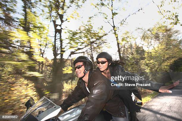 couple cruising on motorcycle - steve prezant stock pictures, royalty-free photos & images