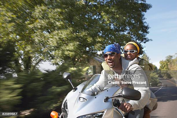 couple riding on motorcycle - steve prezant stock pictures, royalty-free photos & images