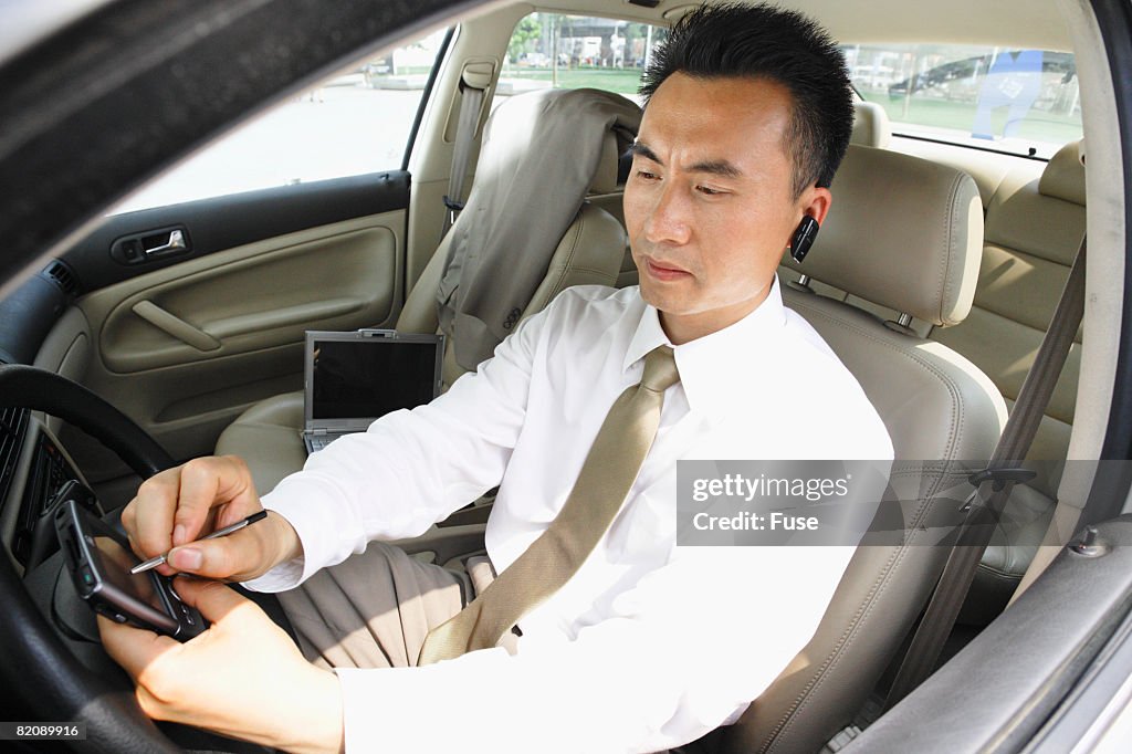 Man on PDA in Car