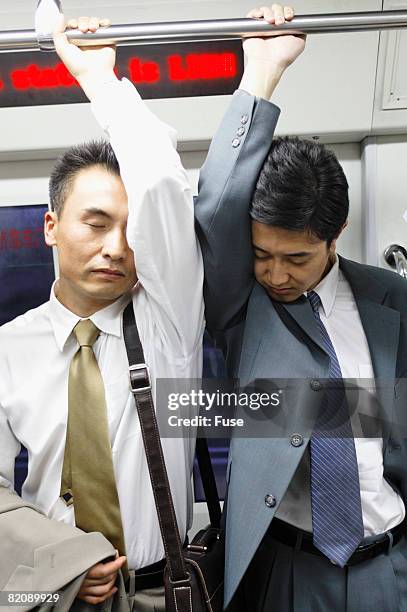 businessmen on subway train - fedor imagens e fotografias de stock