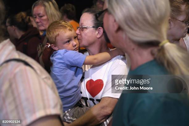 Ruby Partin and her adoptive son Timothy Huff wait for a free clinic to open in the early morning of July 22, 2017 in Wise, Virginia. Hundreds of...