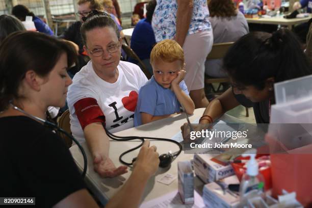 Ruby Partin and her adoptive son Timothy Huff visit a free helath clinic on July 22, 2017 in Wise, Virginia. Hundreds of Appalachia residents waited...