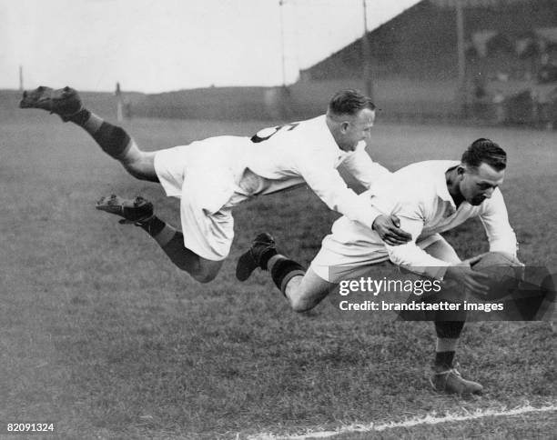 Markham, Australian member of the Huddersfield team bringing down a colleague on the line during tackling practice on Huddersfield ground, England...