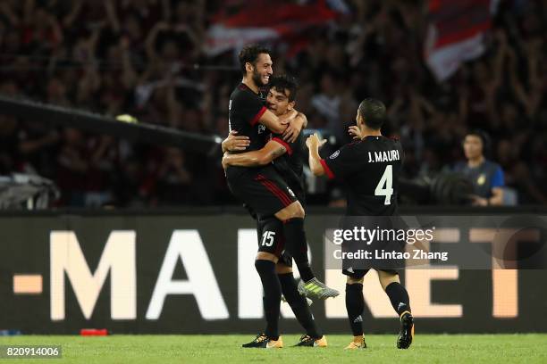 Hakan Calhanoglu of AC Milan celebrates a goal with teammate Jose Mauri and Gustavo Gomez during the 2017 International Champions Cup China match...