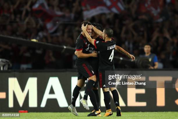 Hakan Calhanoglu of AC Milan celebrates a goal with teammate Jose Mauri and Gustavo Gomez during the 2017 International Champions Cup China match...