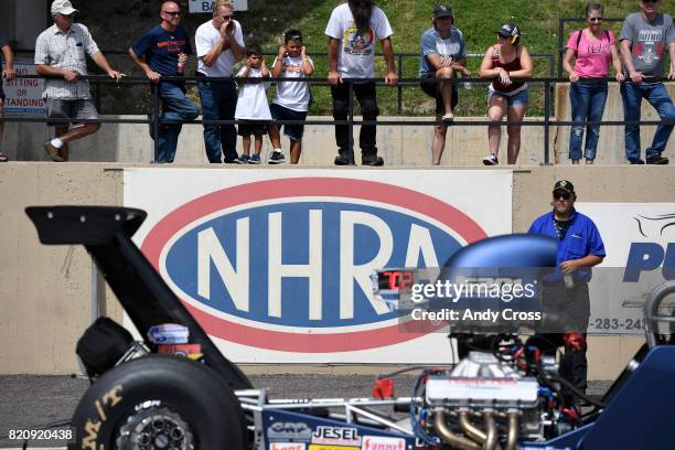 Drag racing fans watch early action at the start line on the second day of the 38th annual NHRA Mopar Mile High Nationals at Bandimere Speedway July...