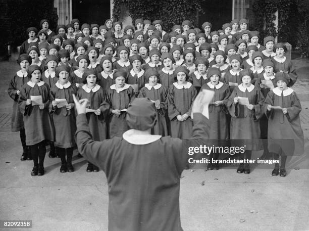 Girl's choir practising outside St, Paul's Cathedral for the Thanksgiving Service preached by the Archbishop of Canterbury, Photograph, 1936 [Ein...
