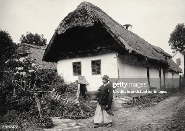 Peasant in front of Croatian farmhouse in Schachendorf, Burgenland, Austria, Photograph, Around 1950 [Bauer vor kroatischem Bauernhaus in...