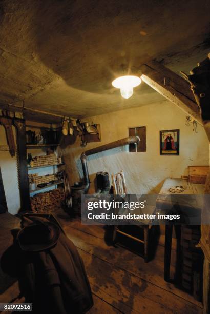 The miller snuggery in the "Wandl-Bretters?ge", nowadays a museum in Kirchbach in the Austrian Waldviertel, With a stovepipe, wooden chair and desk,...