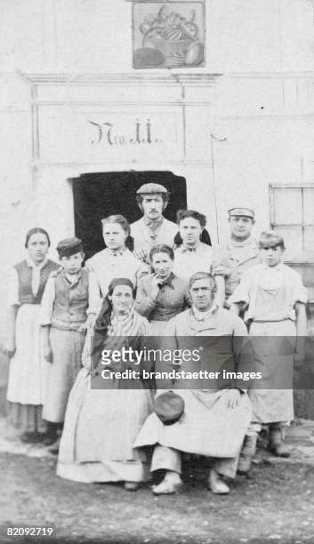 Miller couple from Kremsmuenster, Lower Austria in typical dresses with children and servants in front of their mill, Photograph, Austria, 1872...