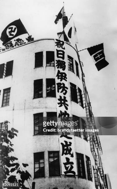 Flags of the allies Japan, Germany and Italy on the building of Japans leading newspaper "Tokyo Yomiuri", Photograph, Japan, December 3rd 1937 [Die...