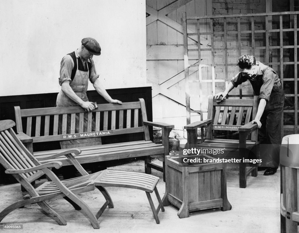 Men polishing furniture made from the teak wood of the ship "Mauretania" which has been broken up, Photogaphy, Scottland, Sept, 16th 1935