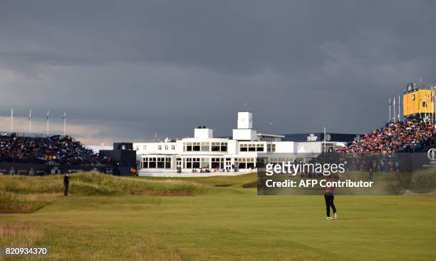 England's Ian Poulter plays from the fairway on the 18th hole towards the Art-Deco-style clubhouse during his third round on day three of the Open...