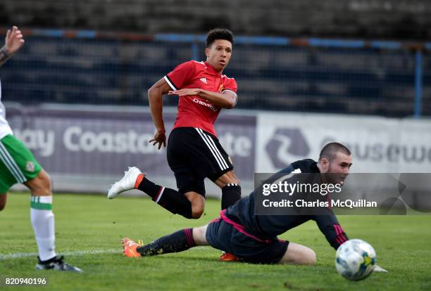 Nishan Burkart of Manchester United sees his shot saved Connor Larkin of Northern Ireland during the NI Super Cup game between Manchester United u18s...