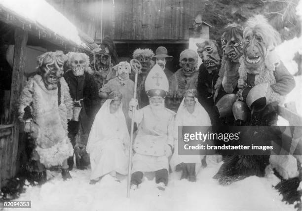 St, Nicholas and his helpers with wooden-carved masks in Matrei, East Tyrol, Photograph, Around 1935 [Nikolaus und die Krampusse mit holzgeschnitzten...