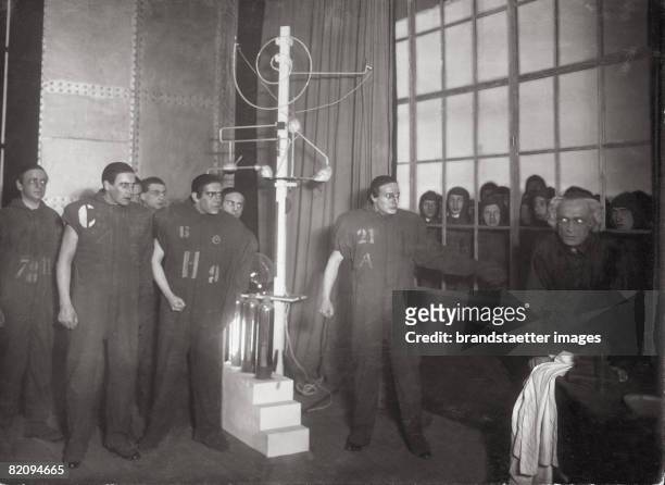 Laboratory scene with robots, "W,U,R," by Karel Capek, Theater am Kurf?rstendamm, Berlin, Photograph, 1923 [Laborszene mit Robotern in "W,U,R," von...