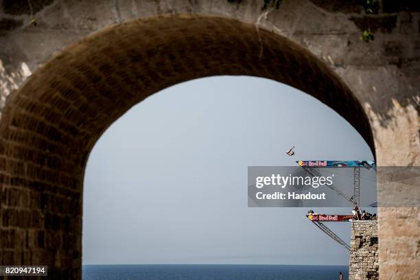 In this handout image provided by Red Bull, Kris Kolanus of Poland dives from the 27 metre platform during the first training session of the third...