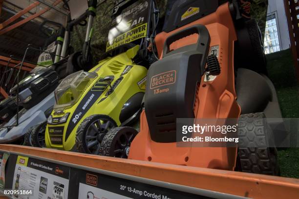 https://media.gettyimages.com/id/820951864/photo/a-stanley-black-decker-inc-lawn-mower-is-displayed-at-a-home-depot-inc-store-in-emeryville.jpg?s=612x612&w=gi&k=20&c=99aFt3Z_zr1SOfo5tdwryvwjCVIY9xubcf8V7ZCCWao=
