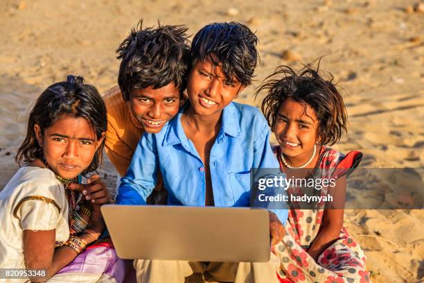 group of happy gypsy indian children using laptop, india - laptop desert stock pictures, royalty-free photos & images